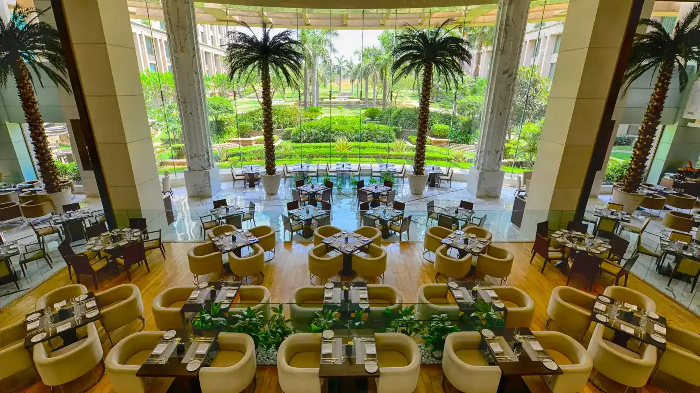 The atrium restaurant at The Grand New Delhi, looking out to the garden