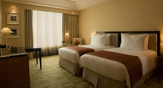 A twin room at The Grand New Delhi